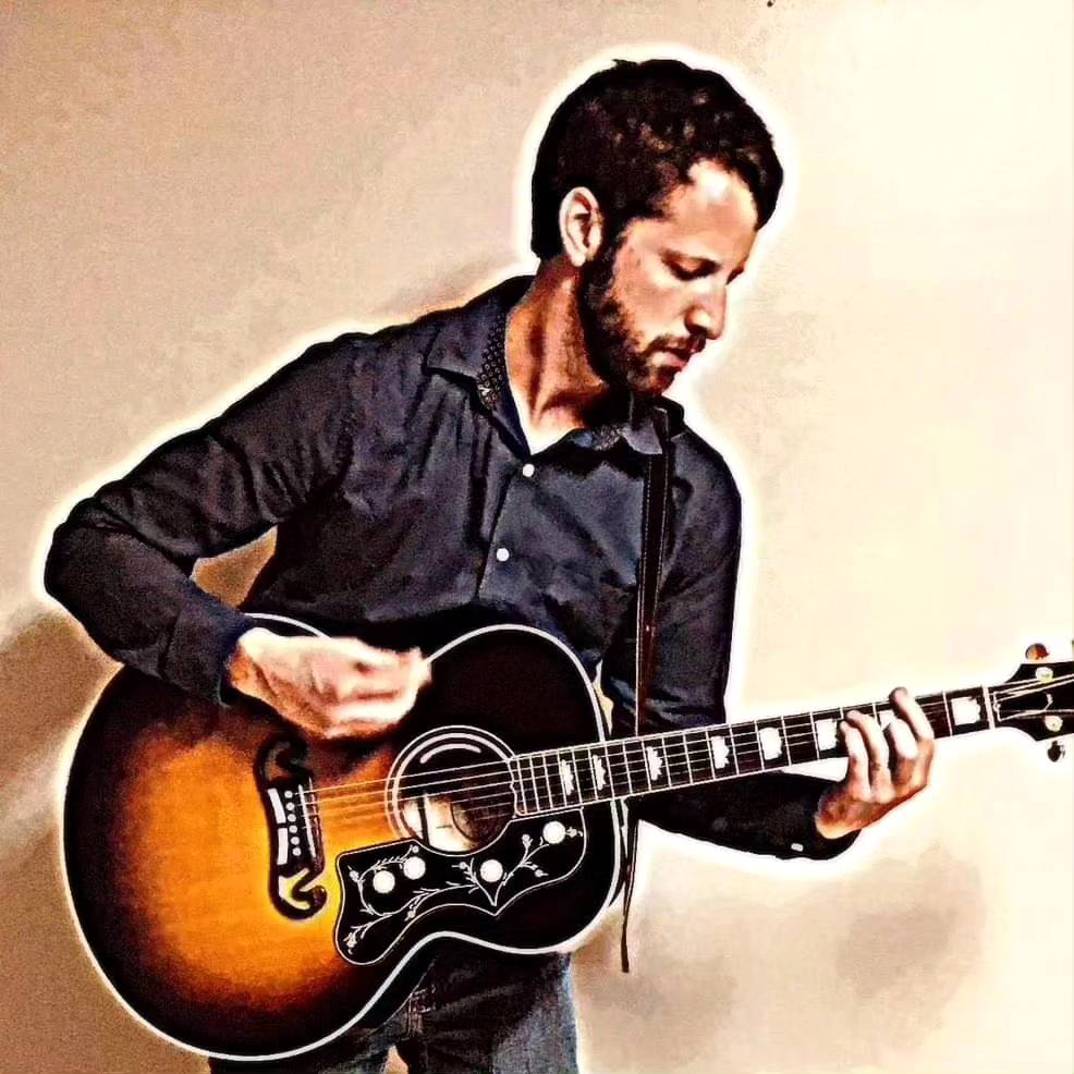 Jason Greene Musician playing a guitar